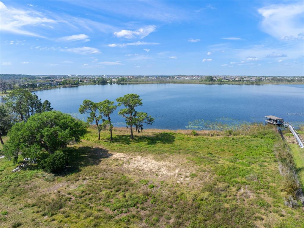 8750 Seidel Road Winter Garden, FL 34787 - Photo 9 of 17 a view of a lake with houses in the back