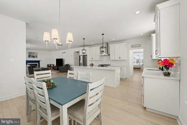 a large kitchen with granite countertop a sink cabinets and stainless steel appliances