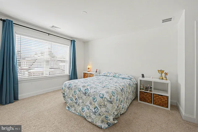 a bedroom with a bed and a dresser in it