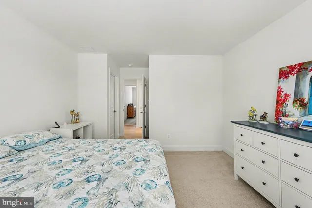 a bedroom with a bed and a dresser in it