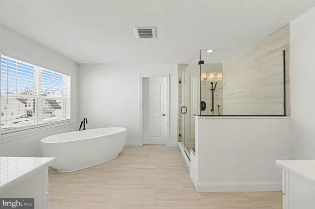 a bathroom with a shower sink and mirror