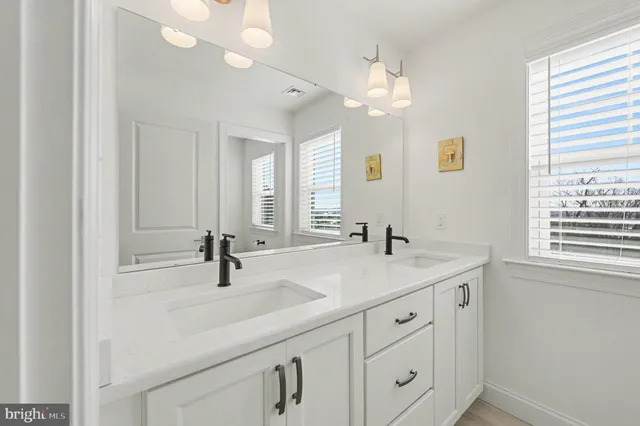 a bathroom with a sink and a window