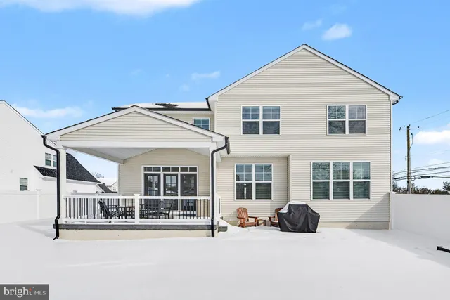 a view of a white house with a road