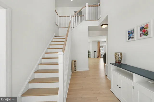 a view of entryway and hall with wooden floor