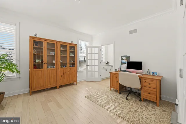 a living room with a balcony a couch and a potted plant