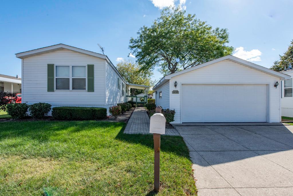 a front view of house with yard and green space