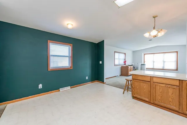 a spacious bedroom with a bed and window