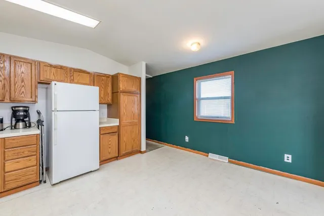 a kitchen with a refrigerator and a refrigerator