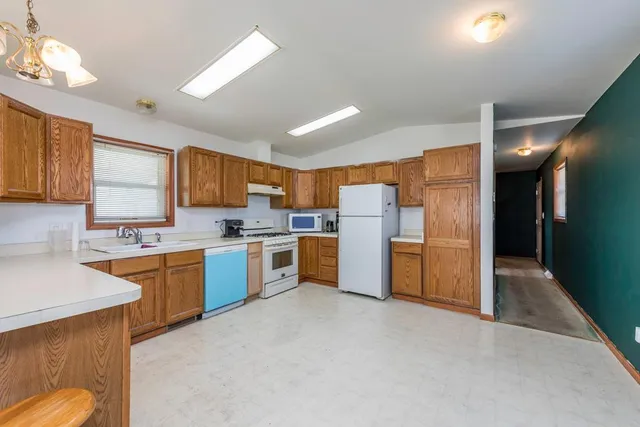 a kitchen with refrigerator and cabinets