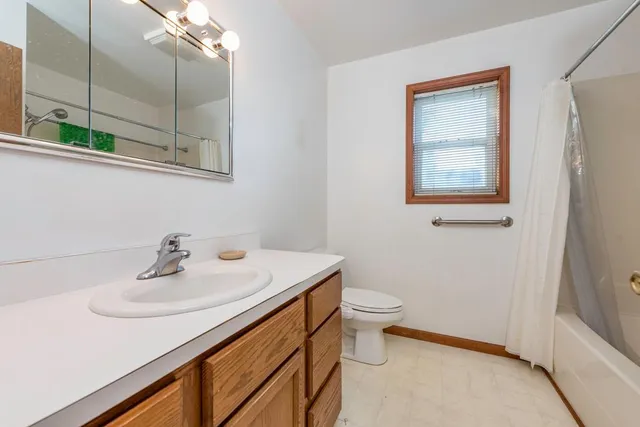 a bathroom with a sink a toilet and mirror