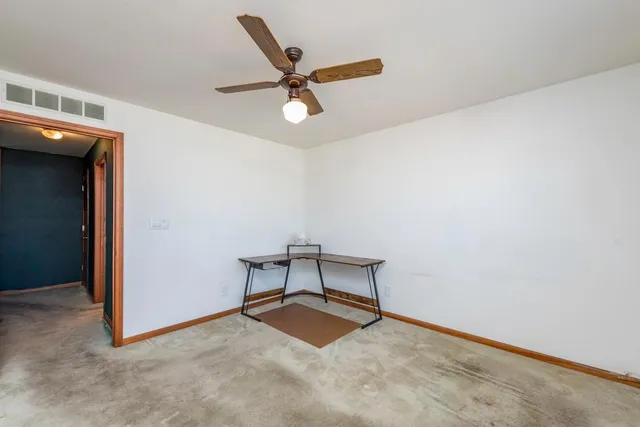 a view of a livingroom with a ceiling fan and wooden floor