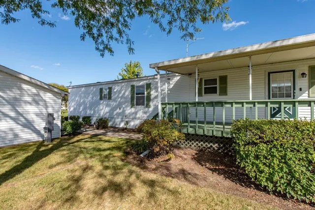 a view of a house with a small yard and plants