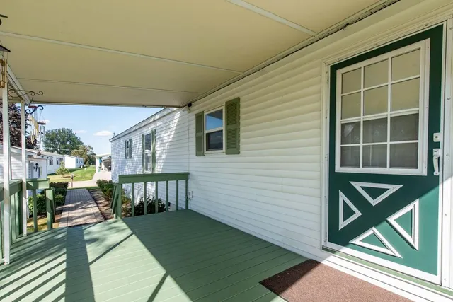 a view of a porch with furniture and floor to ceiling window
