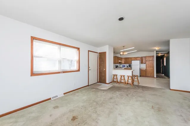 a view of a livingroom with furniture and a window