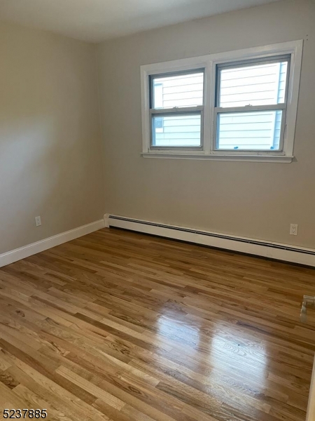 28 Boyd Street, Unit 2 Lodi, NJ 07644 - Photo 4 of 9 a view of an empty room with wooden floor and a window