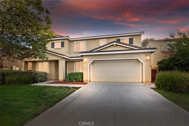 a front view of a house with a yard and garage