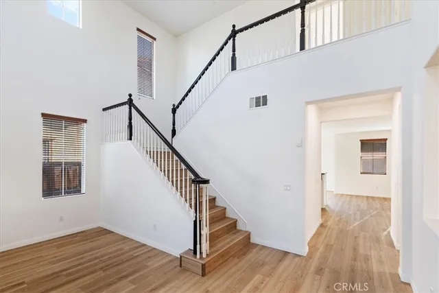 a view of entryway with wooden floor and stairs