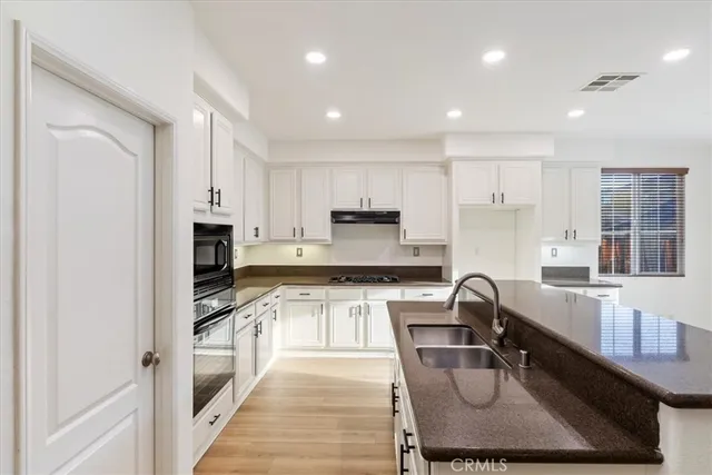 an empty room with a window and a ceiling fan
