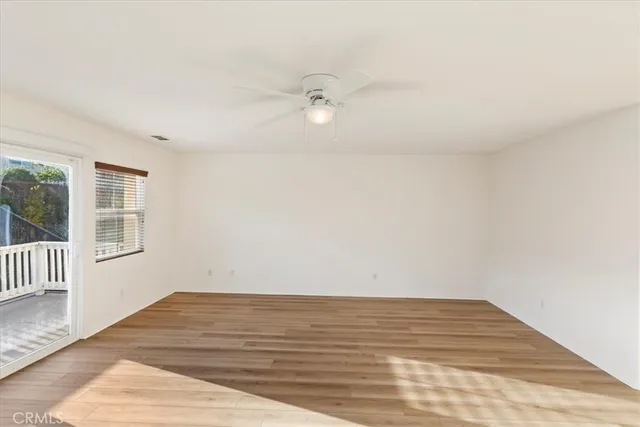 a view of a room with wooden floor and fan