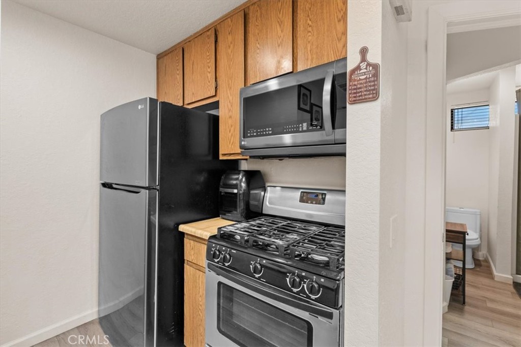 760 Bluejay Road, Unit 26 Big Bear Lake, CA 92315 - Photo 11 of 35 a kitchen with stainless steel appliances granite countertop a refrigerator stove and microwave