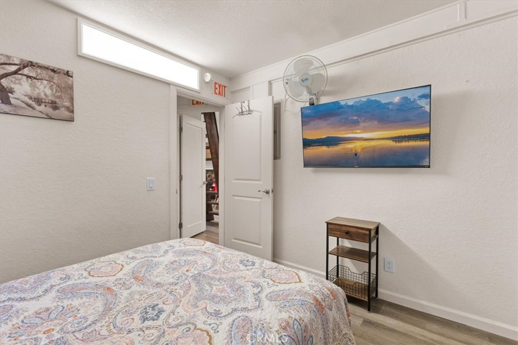 760 Bluejay Road, Unit 26 Big Bear Lake, CA 92315 - Photo 15 of 35 a bedroom with a bed and a flat screen tv