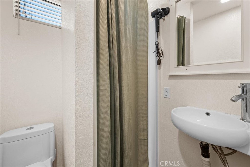 760 Bluejay Road, Unit 26 Big Bear Lake, CA 92315 - Photo 16 of 35 a bathroom with a sink a toilet and shower