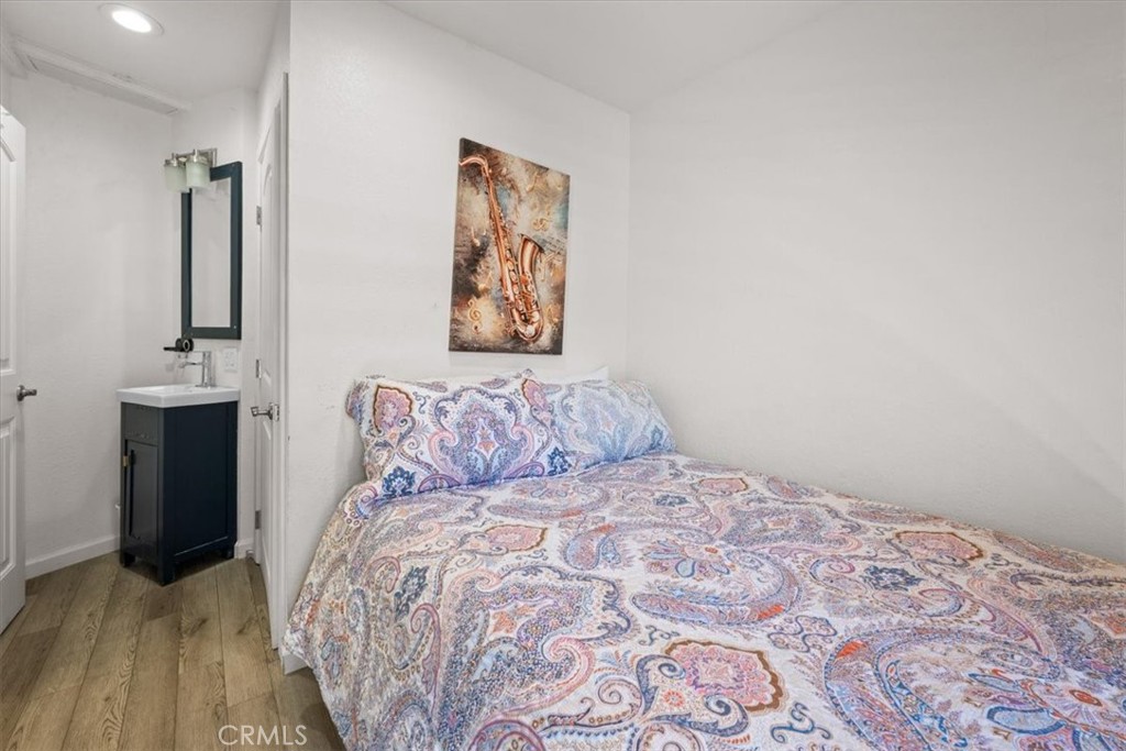 760 Bluejay Road, Unit 26 Big Bear Lake, CA 92315 - Photo 18 of 35 a large bed sitting in a bedroom and painting on the wall