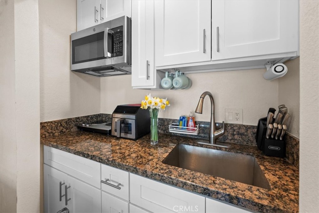 760 Bluejay Road, Unit 26 Big Bear Lake, CA 92315 - Photo 28 of 35 a kitchen with granite countertop a sink stainless steel appliances and cabinets