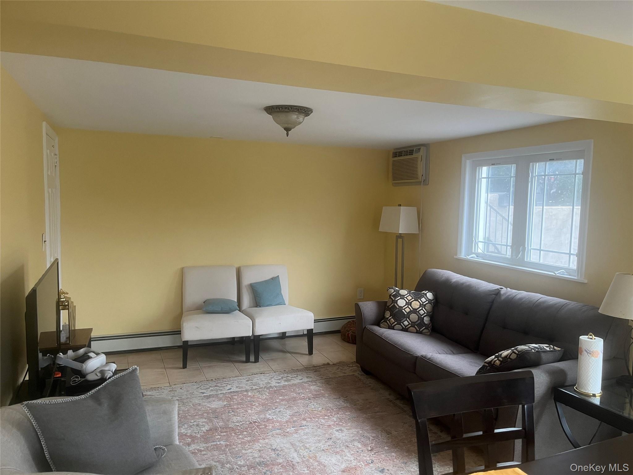 13 Summitt Place Valhalla, NY 10595 - Photo 6 of 10 a living room with furniture and a flat screen tv