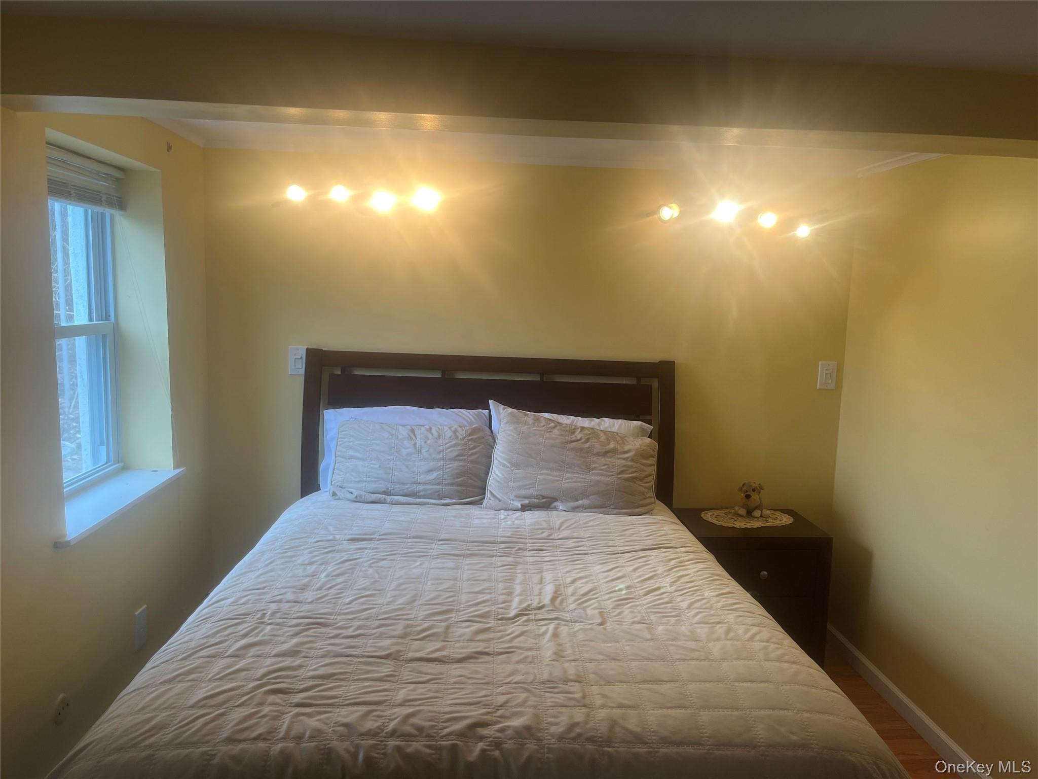 13 Summitt Place Valhalla, NY 10595 - Photo 9 of 10 a bedroom with a bed and a night stand