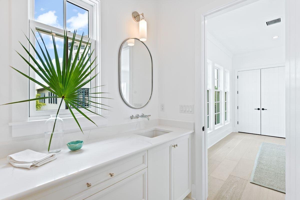165 North Charles Street Inlet Beach, FL 32461 - Photo 25 of 38 a bathroom with a double vanity sink and a mirror