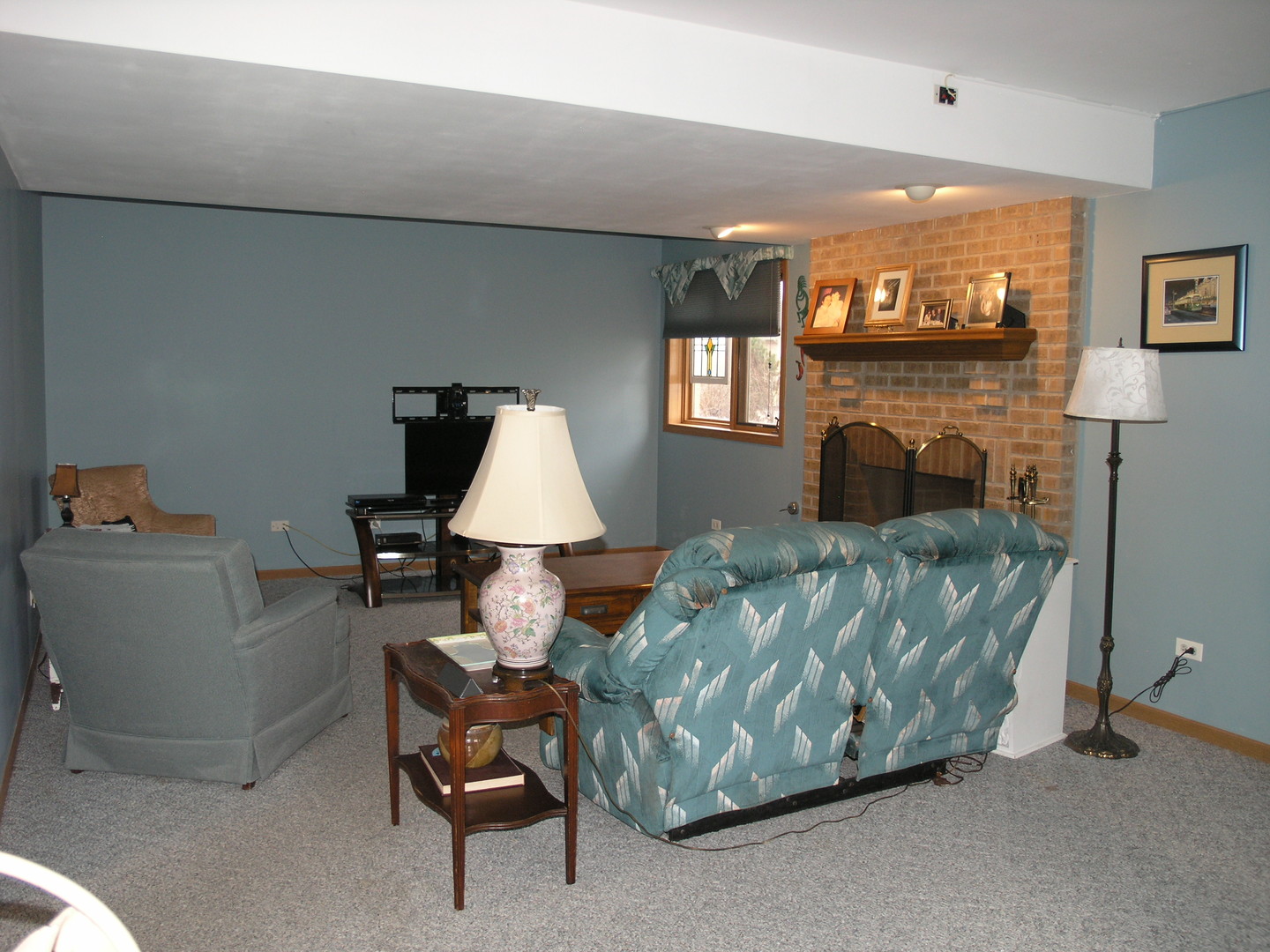 304 Georgetown Avenue Romeoville, IL 60446 - Photo 12 of 17 a living room with furniture and a fireplace