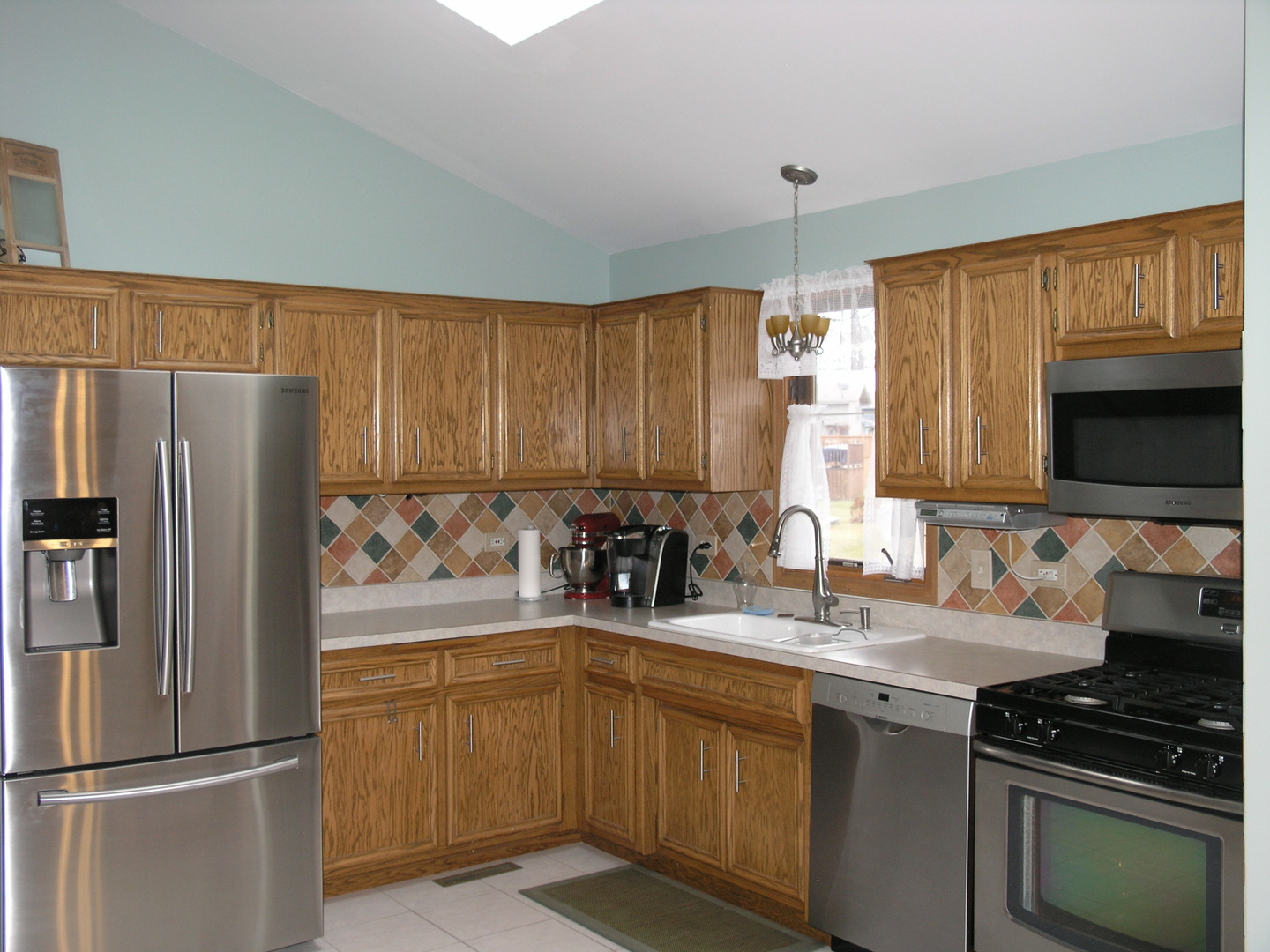 304 Georgetown Avenue Romeoville, IL 60446 - Photo 2 of 17 a kitchen with refrigerator and cabinets