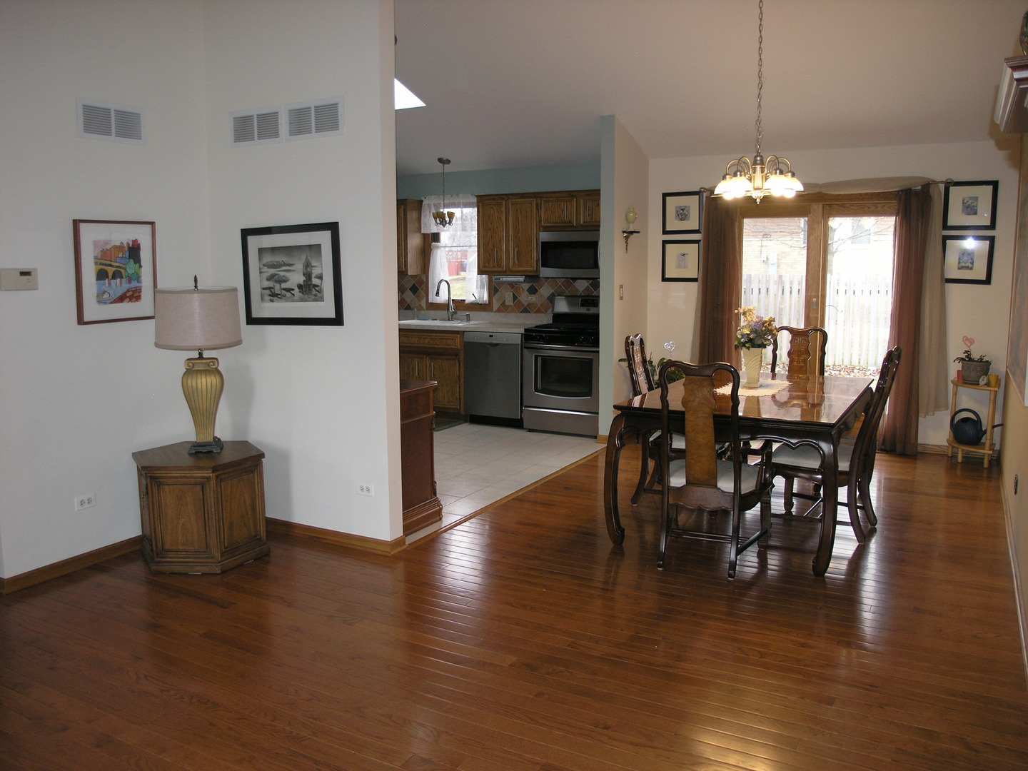 304 Georgetown Avenue Romeoville, IL 60446 - Photo 3 of 17 a view of a dining room with furniture window and wooden floor