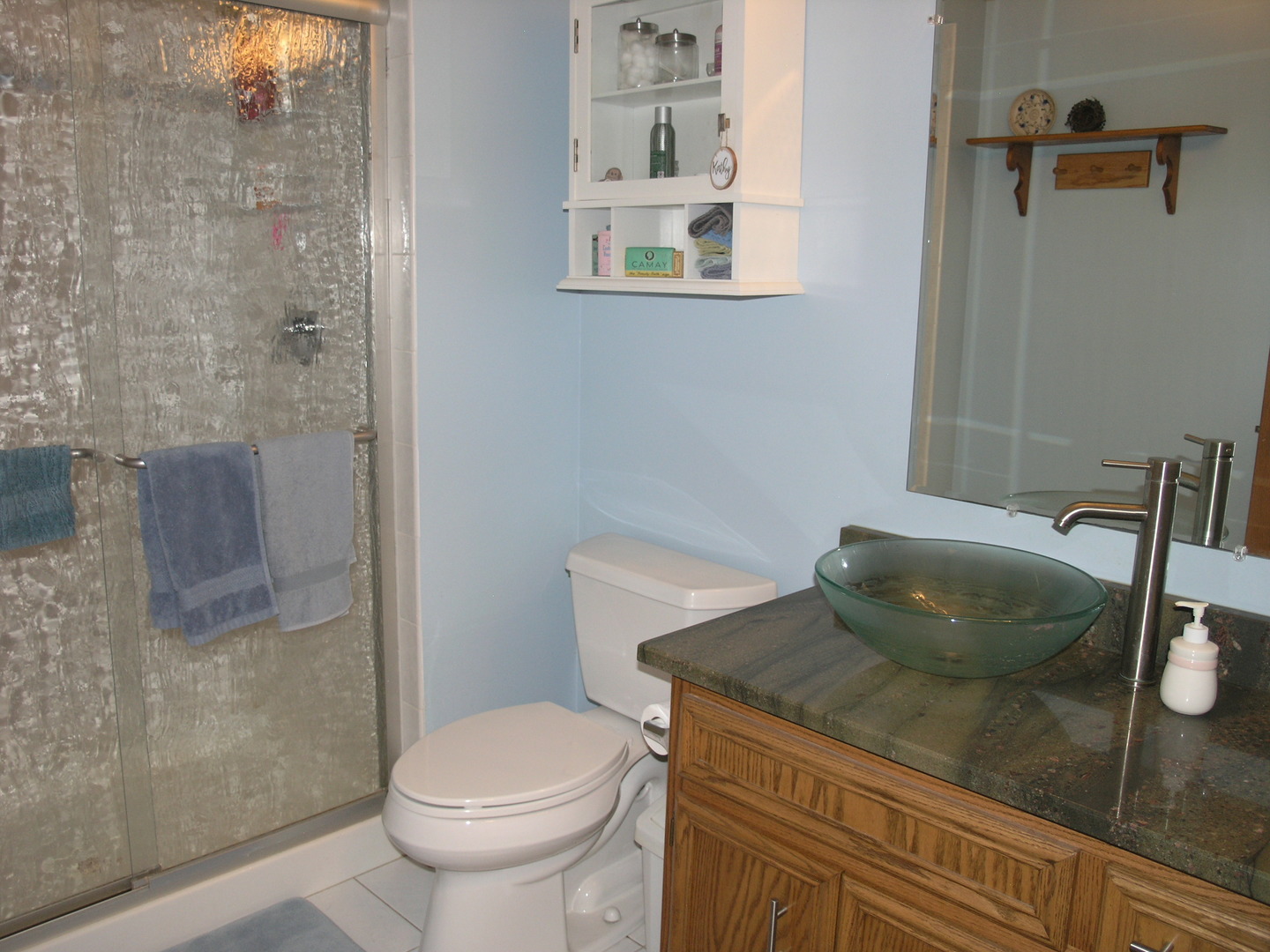 304 Georgetown Avenue Romeoville, IL 60446 - Photo 10 of 17 a bathroom with a granite countertop sink a toilet and a shower