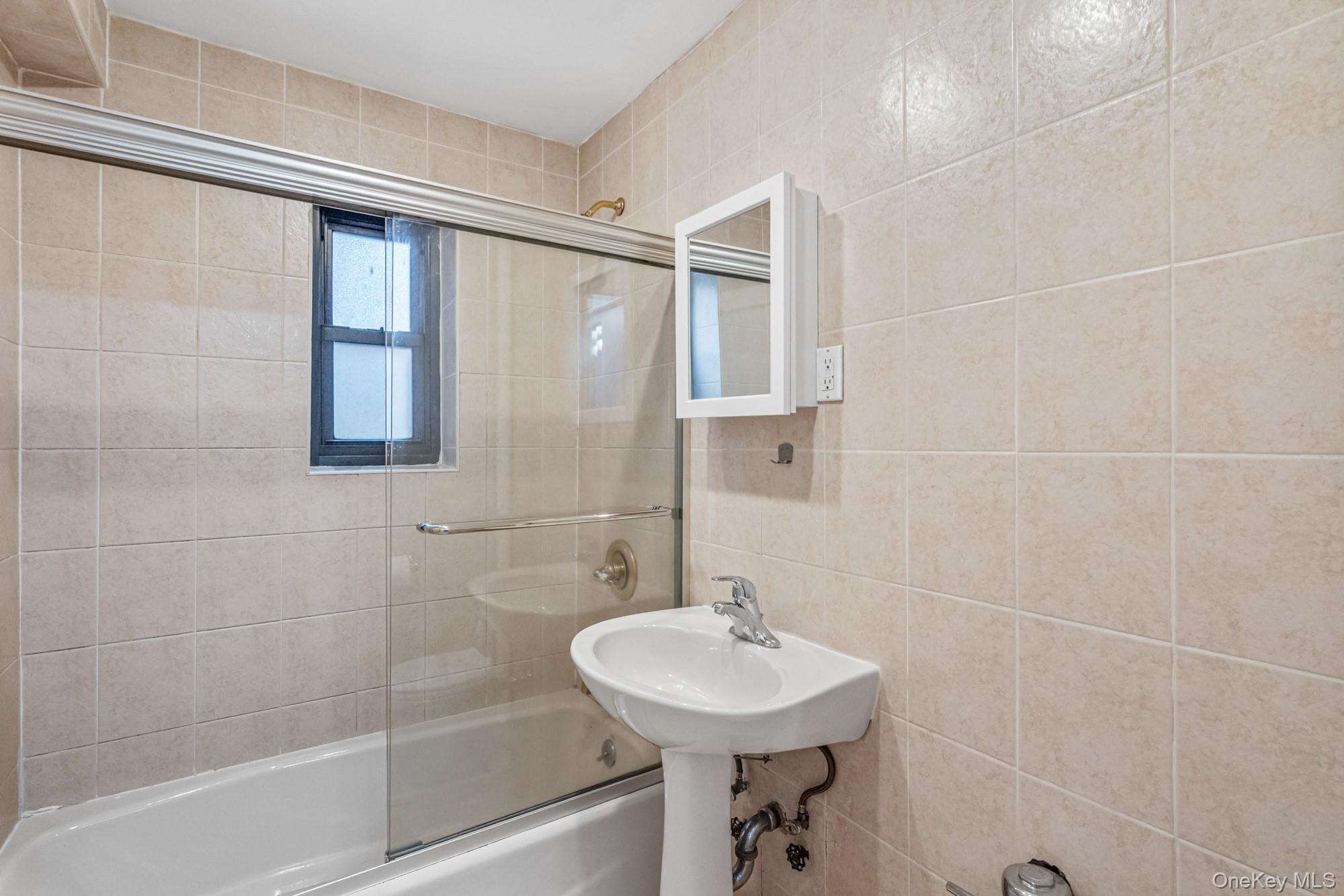 102-55 67th Road, Unit 2V Queens, NY 11375 - Photo 11 of 14 a bathroom with a sink mirror toilet and shower