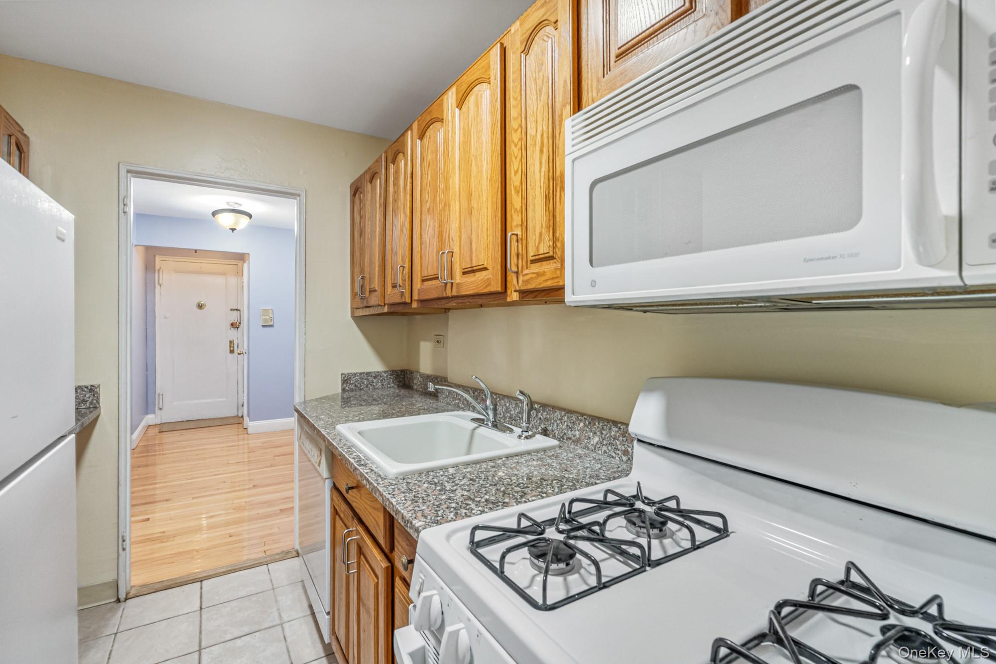 102-55 67th Road, Unit 2V Queens, NY 11375 - Photo 8 of 14 a kitchen with a sink and a stove top oven