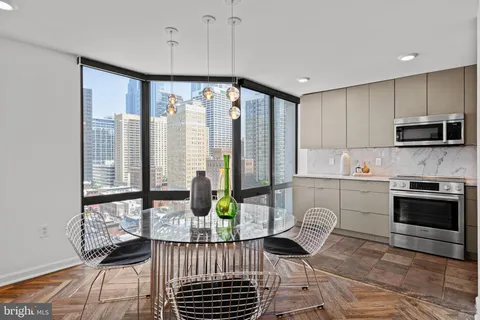 a kitchen with stainless steel appliances kitchen island granite countertop a stove a sink and a microwave