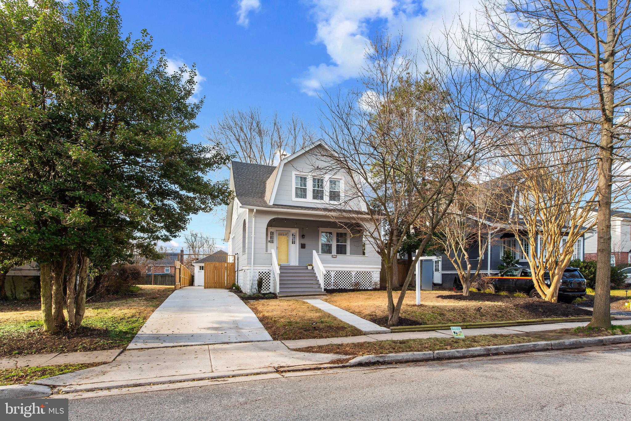 a front view of a building with trees