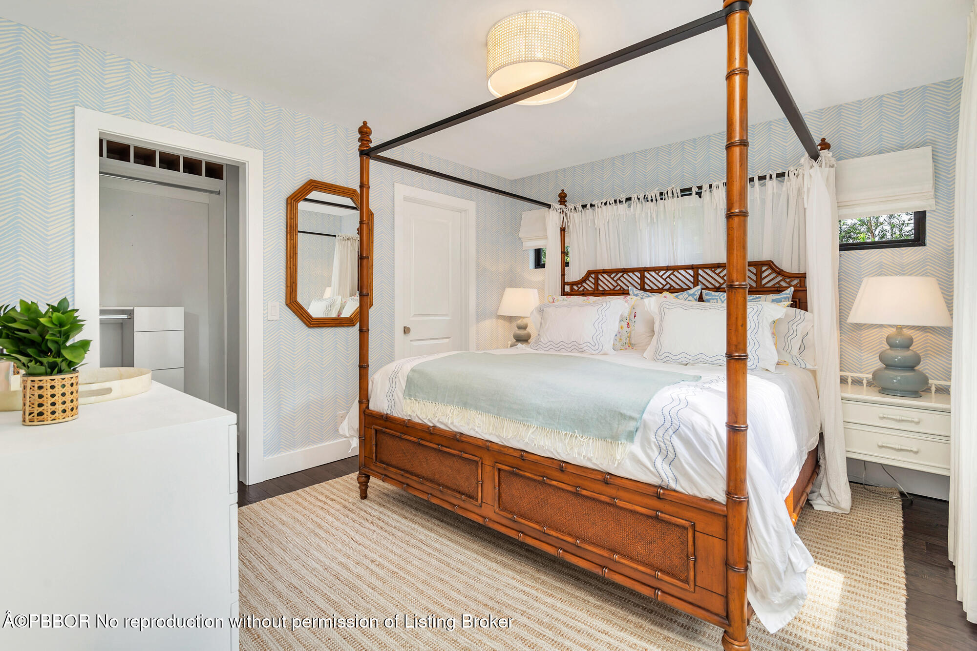 3210 Vincent Road West Palm Beach, FL 33405 - Photo 11 of 20 a bedroom with a bed a mirror and a potted plant