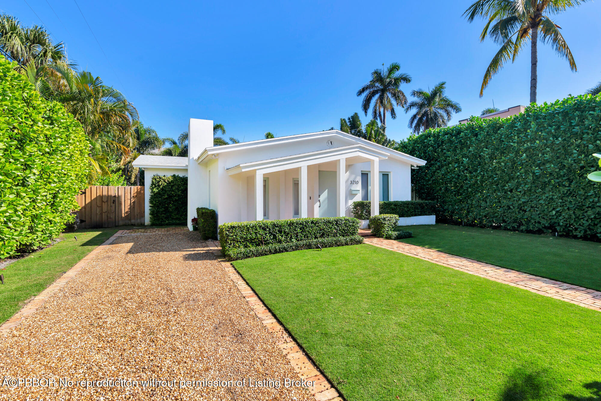 3210 Vincent Road West Palm Beach, FL 33405 - Photo 2 of 20 a front view of a house with a garden