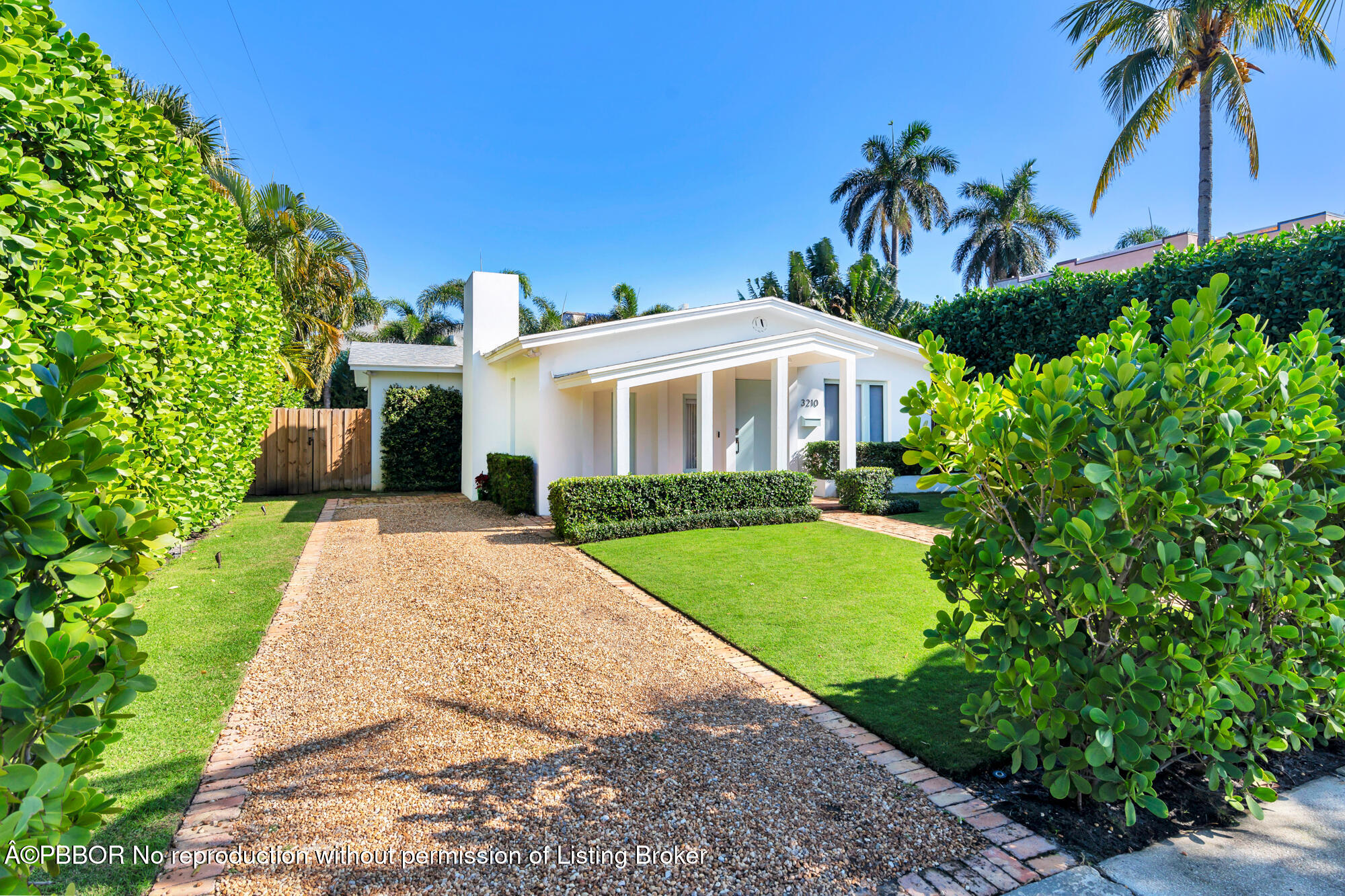 3210 Vincent Road West Palm Beach, FL 33405 - Photo 4 of 20 a front view of a house with a garden and yard