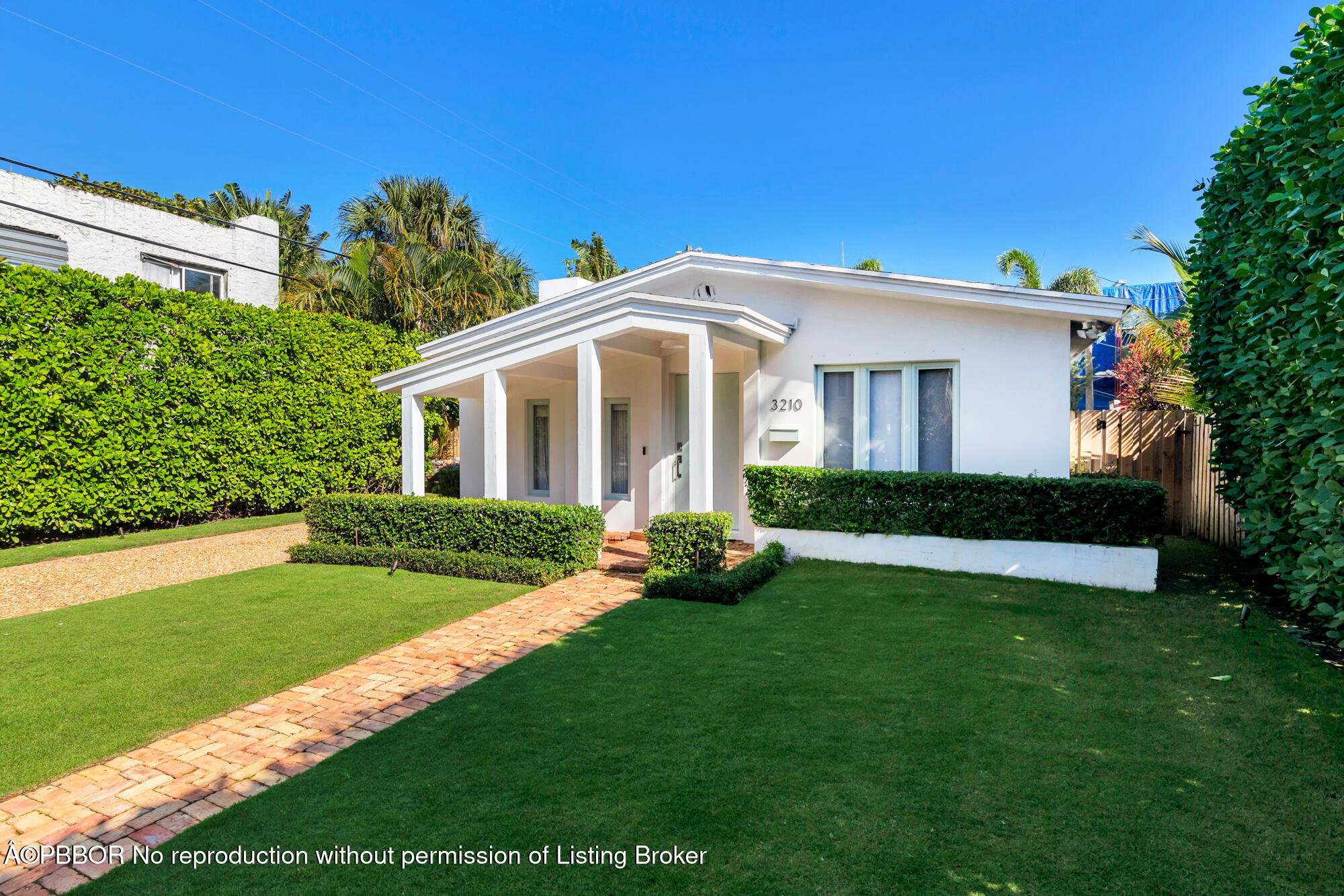 3210 Vincent Road West Palm Beach, FL 33405 - Photo 5 of 20 a front view of a house with a garden and yard