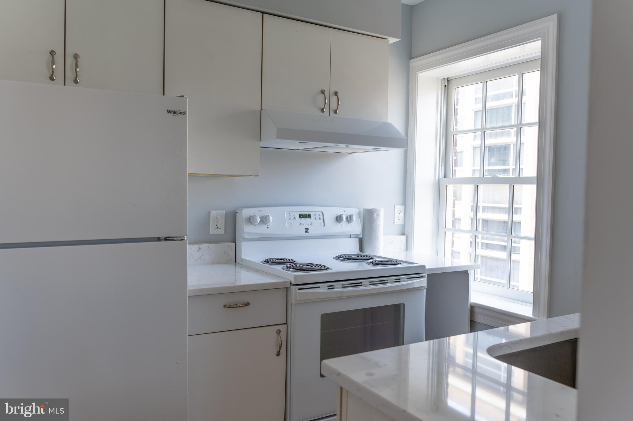 1426 21st Street Northwest, Unit 407 Washington, DC 20036 - Photo 18 of 58 a kitchen with stainless steel appliances granite countertop a stove a refrigerator and a white cabinets