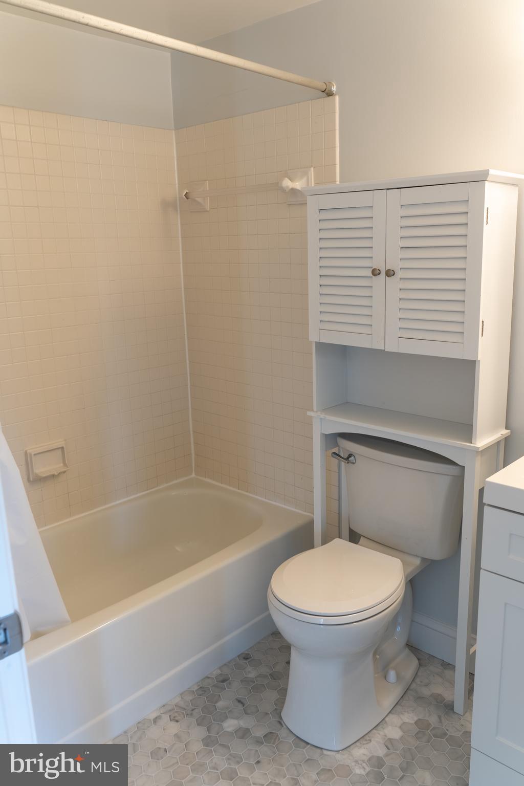 1426 21st Street Northwest, Unit 407 Washington, DC 20036 - Photo 23 of 58 a white toilet sitting next to a bath tub and shower