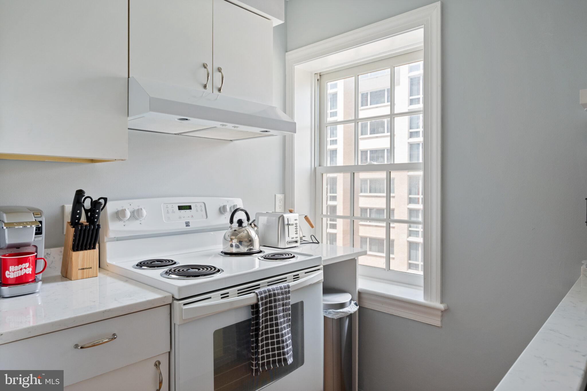 1426 21st Street Northwest, Unit 407 Washington, DC 20036 - Photo 4 of 58 a kitchen with a stove and a sink
