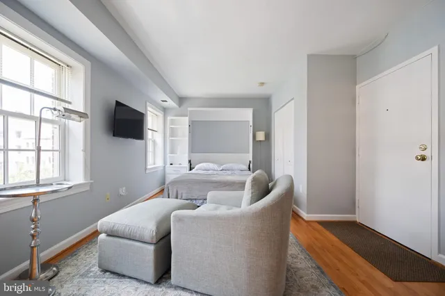 a bed room with furniture and a window