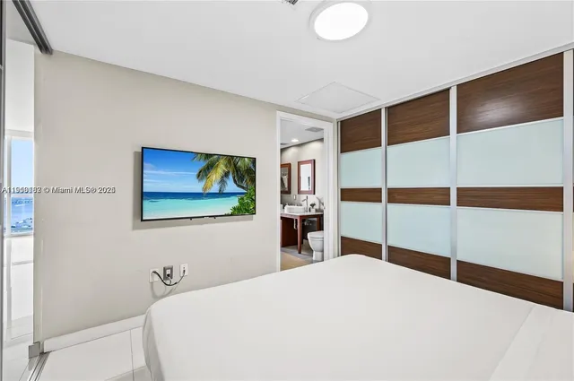 a bedroom with a bed and wall painting