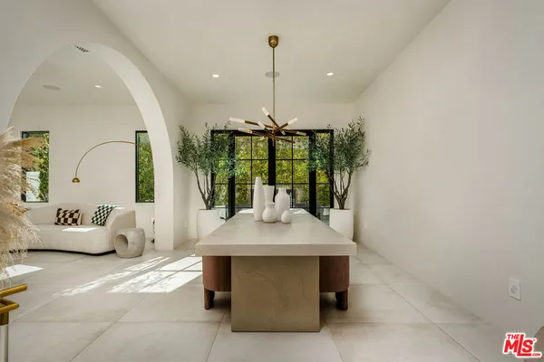 a room with a table chairs and entryway