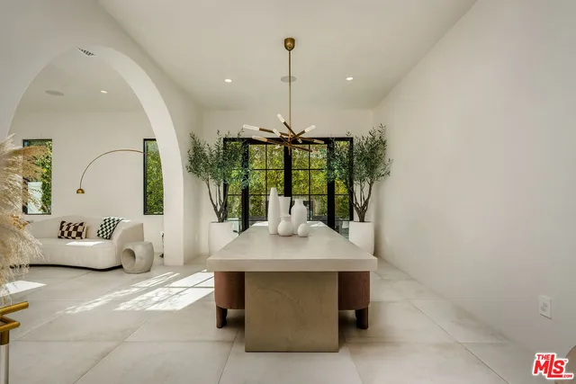 a room with a table chairs and entryway